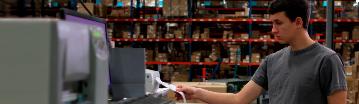 Man printing shipping label in warehouse