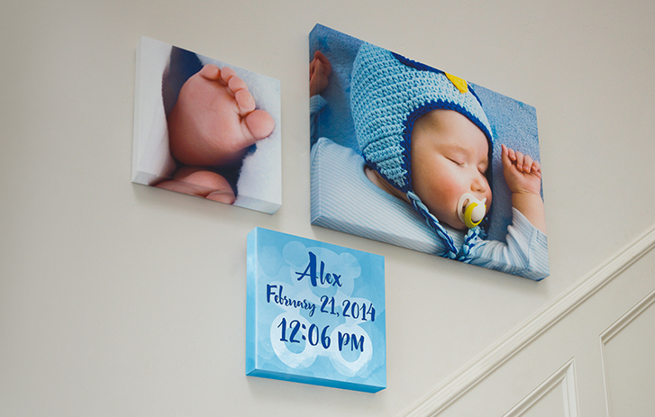 A image of different sized canvas prints of children on a wall