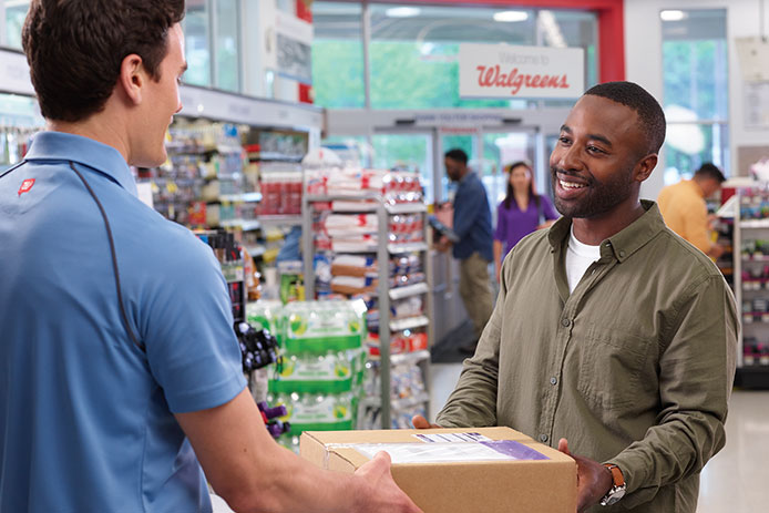 Customer picking up his package from a FedEx Office location