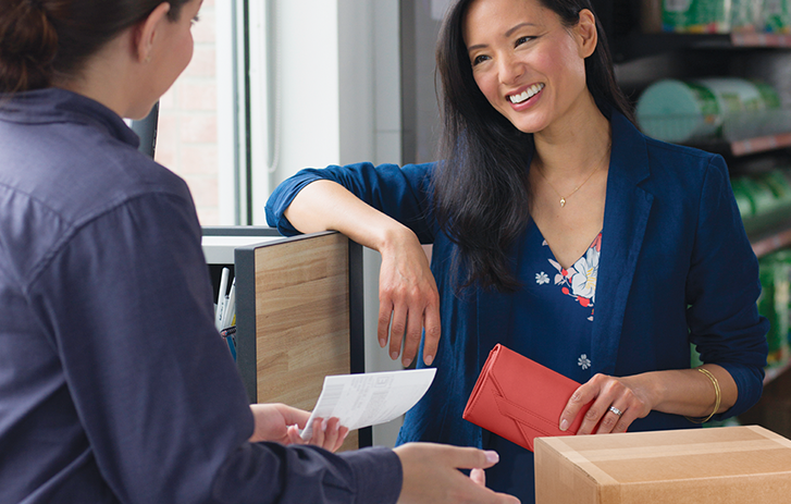 Fedex Employee helping customer with shipment