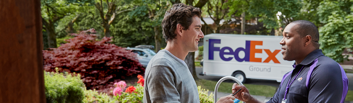Customer receiving package from FedEx driver