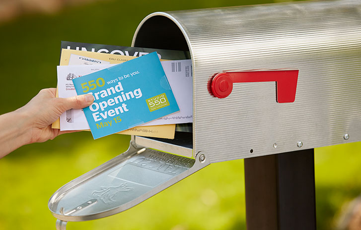 Direct Mail Advertising Person grabbing direct mail out of a mailbox