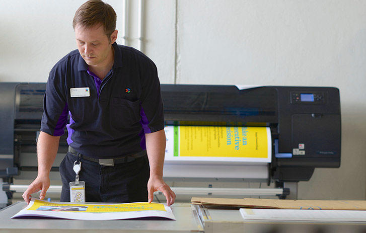 Manufacturing A FedEx employee using a commercial printer