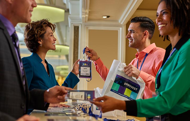 Printing Capabilities Summit attendees collecting badges