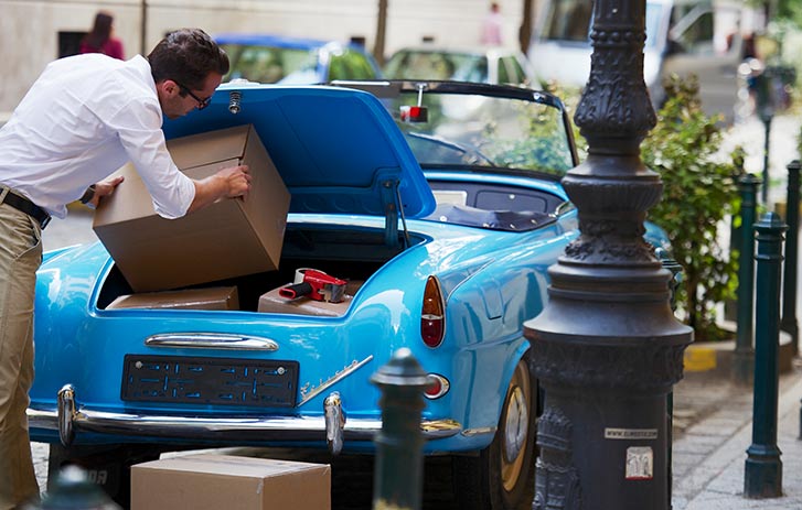 Customer loading a box into a car