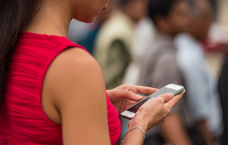 Customer using her mobile device to redirect her package
