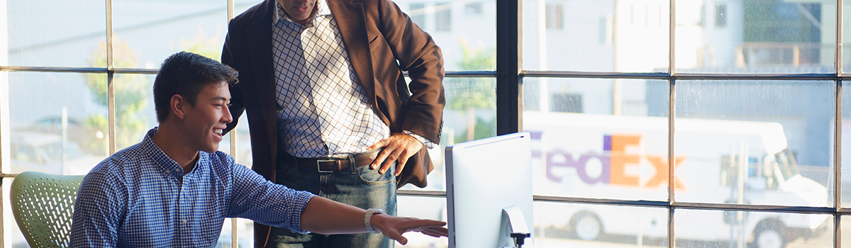 Two business people looking at a computer