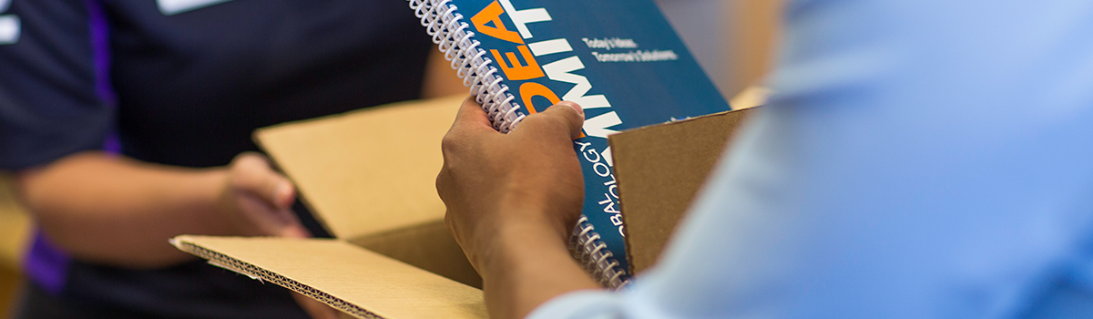 Fedex Office Associate unboxing a package