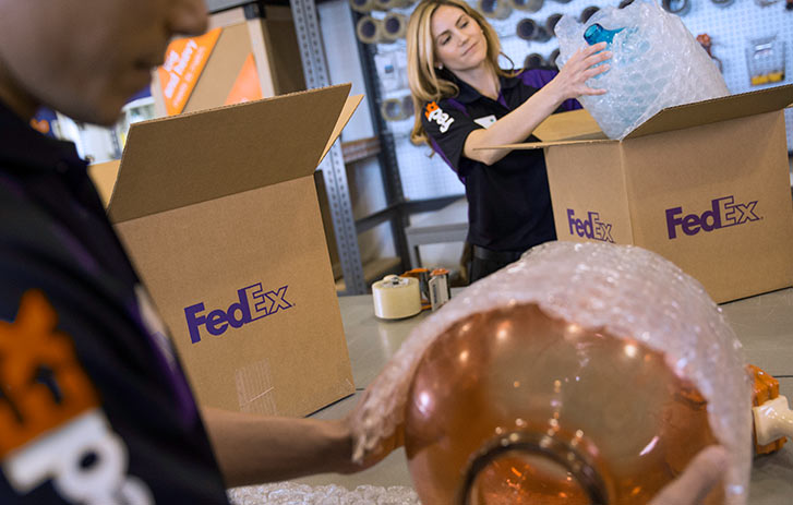 FedEx associates packing items in-store