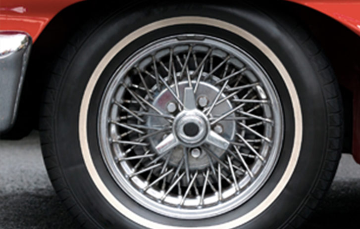 Close up photo of the tire and fender of a classic car