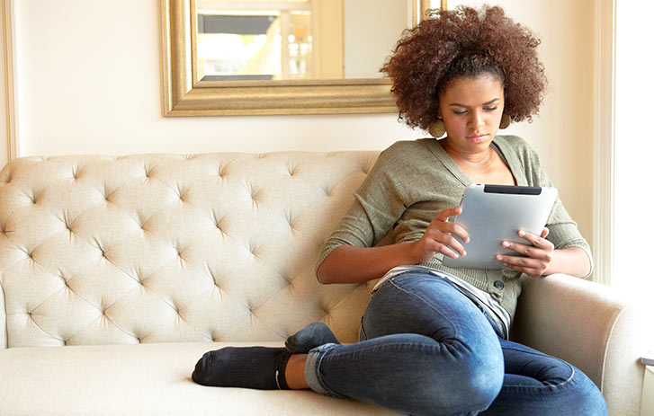 Woman using a tablet at home