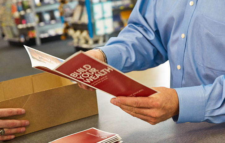 Traditional Direct Mail Customer looking at brochures for direct mail