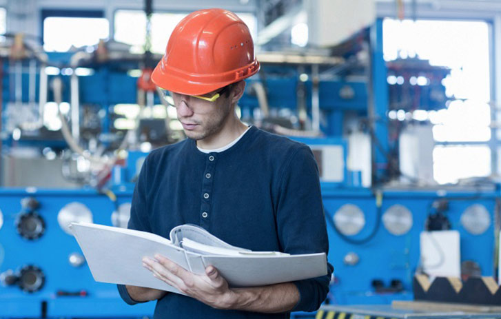 a worker reviewing a training manual