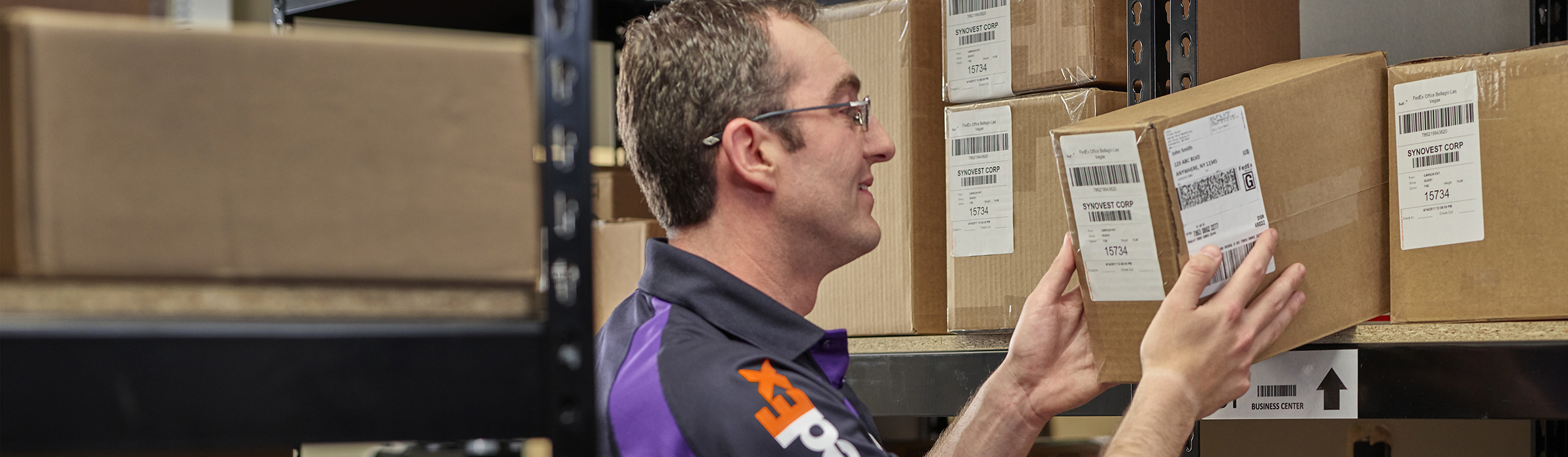 FedEx Office Associate helping a customer with a package