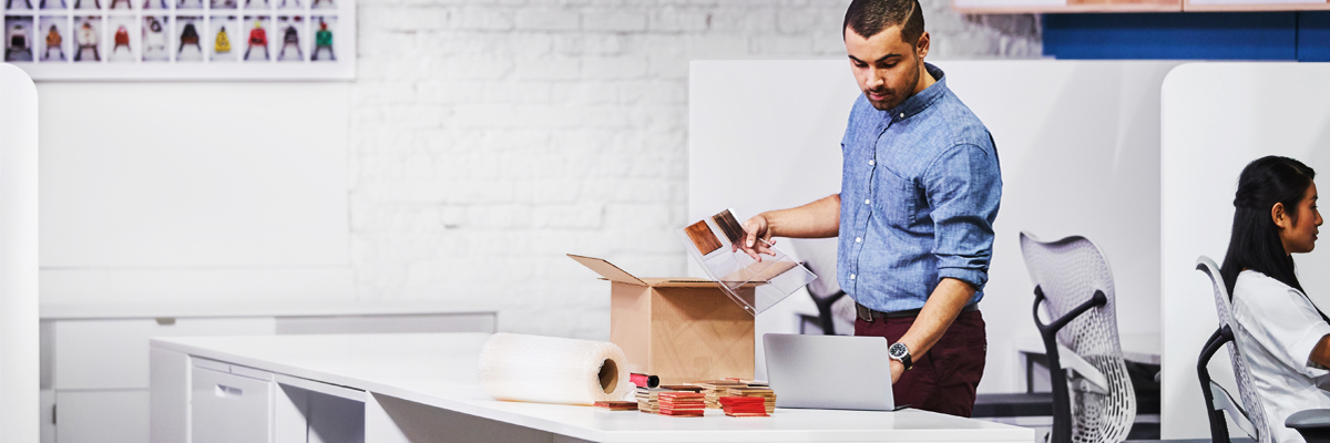 Man using shipping supplies for packing