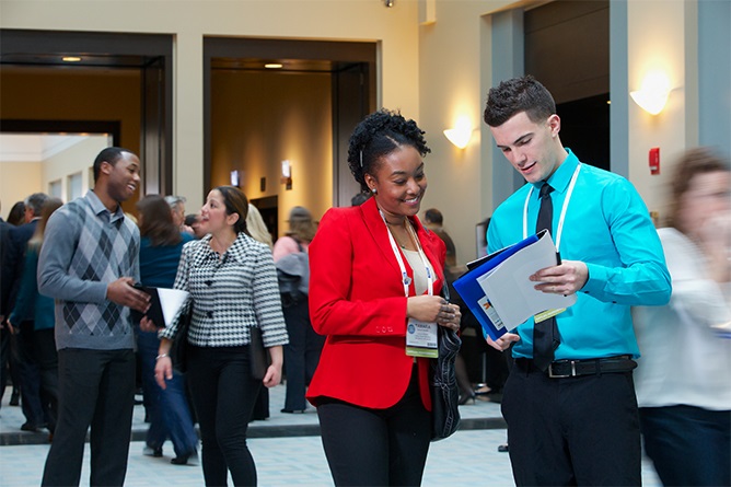 Two people discussing paperwork