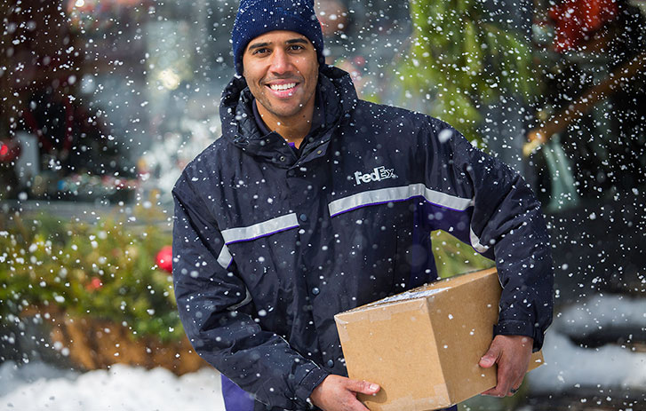fedex driver delivering package to doorstep