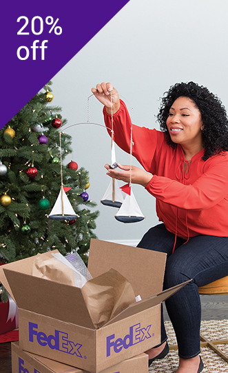 lady opening a FedEx brown box at Christmas