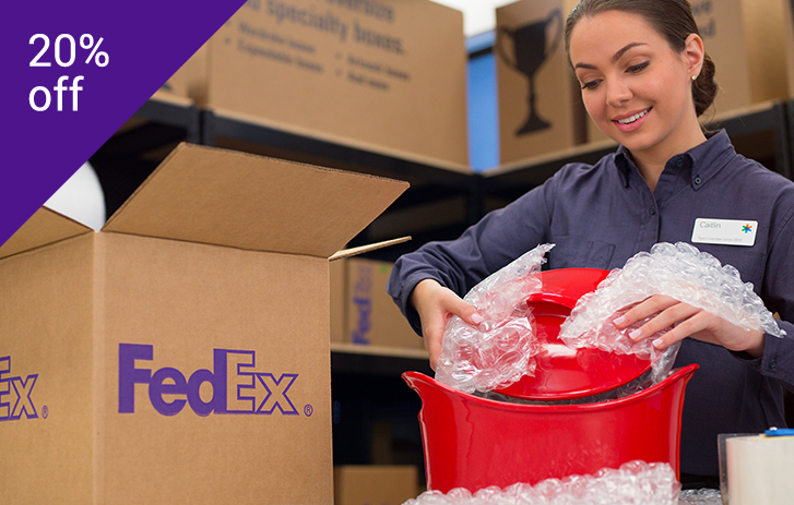 Get packed by the pros FedEx Office employee packing an item - holiday version