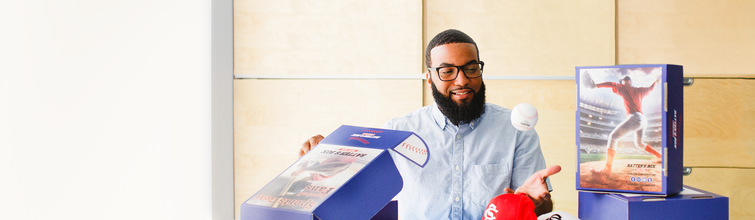 A man showing a custom branded box with a sports theme