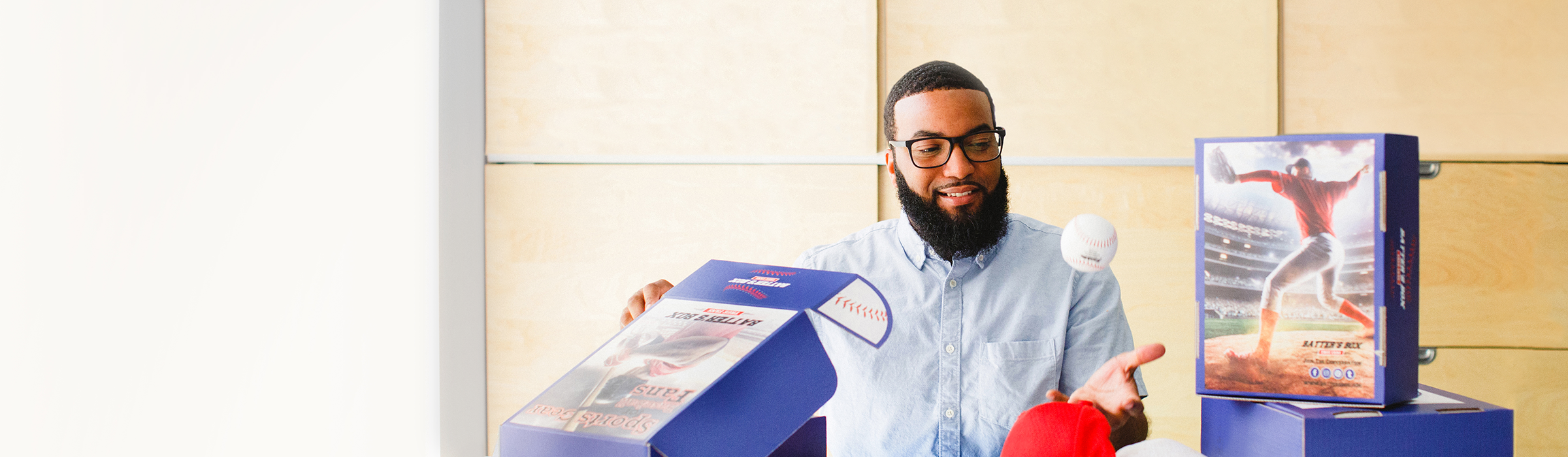 A man showing a custom branded box with a sports theme