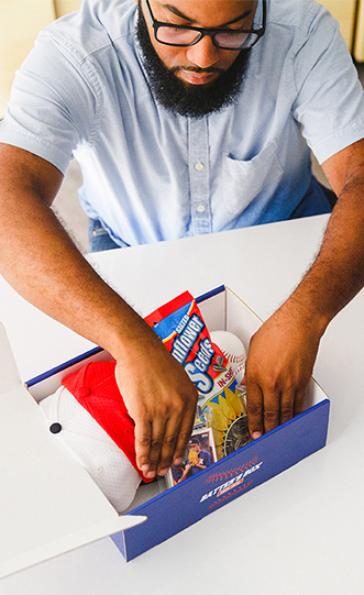 a man packing a sports themed custom branded box