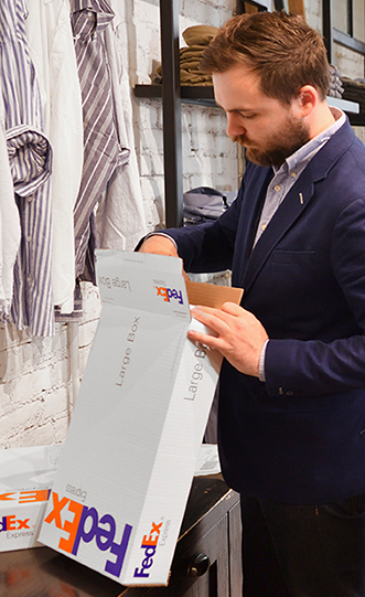 Business man opening a FedEx package