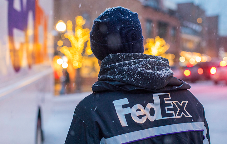 FedEx Delivery driver near a delivery truck