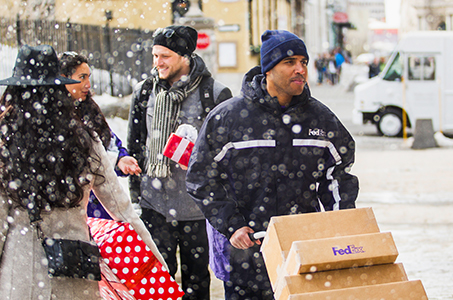 fedex driver delivering packages in winter