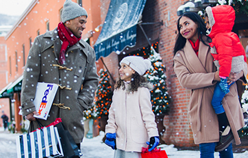 family running errands on snowy sidewalk