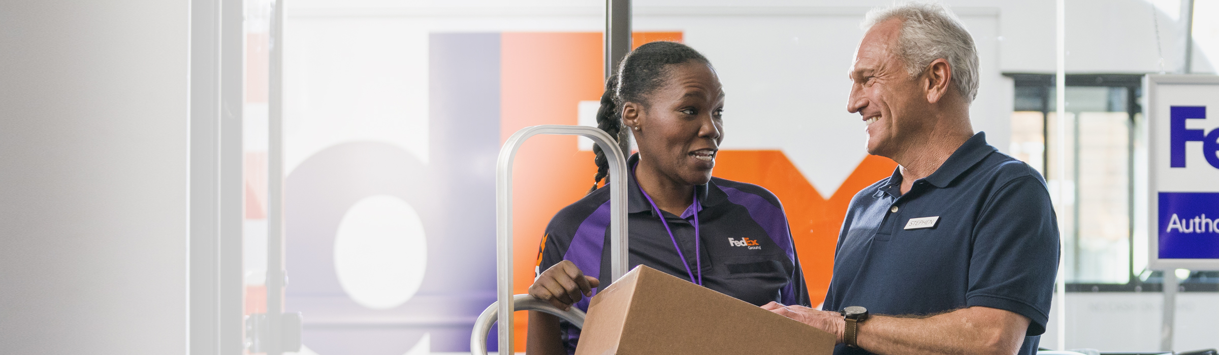 FedEx employee helping a customer with a package