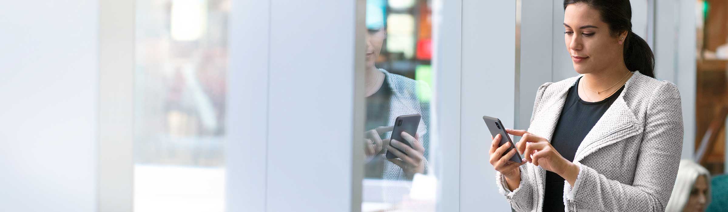 A woman using a smart phone in a residence