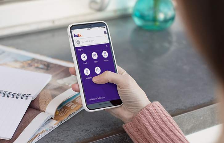 A woman using the FedEx Mobile App on a smart phone