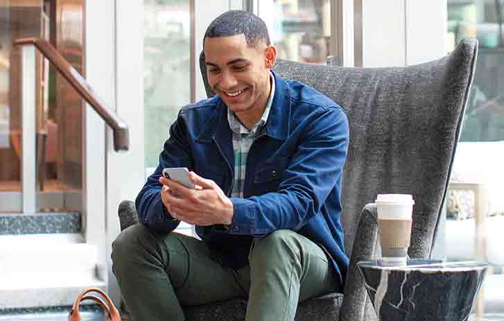 Man sitting in chair on phone