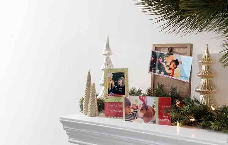 holiday cards on a mantle