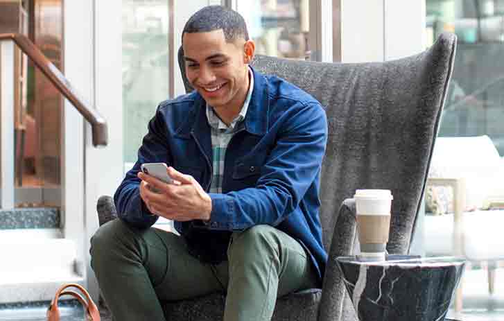 Customer on his mobile phone and learning about saving