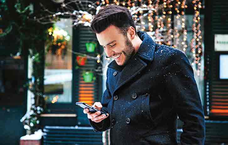 FedEx Delivery Manage Customer using his mobile phone to redirect packages