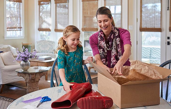 Mother and daughter packing some items