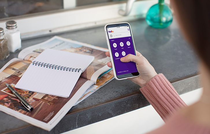 Customer using mobile phone to track packages