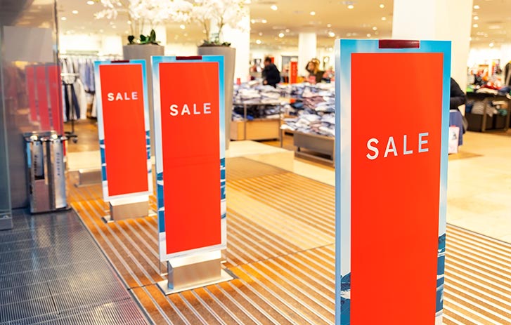 Red vertical sale banners at store entrance