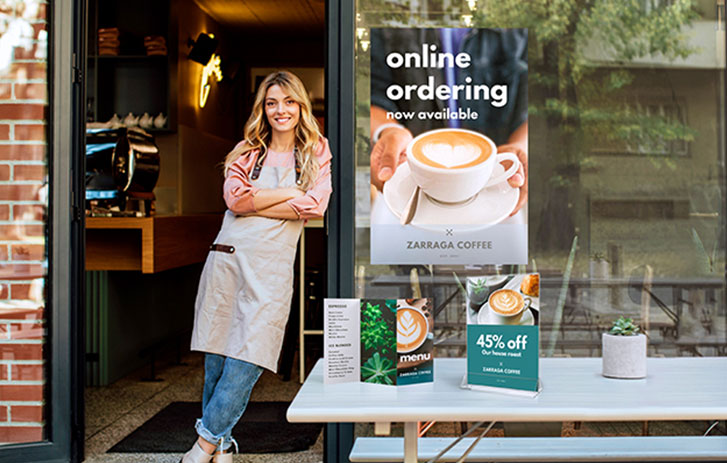 woman next to a table of marketing materials