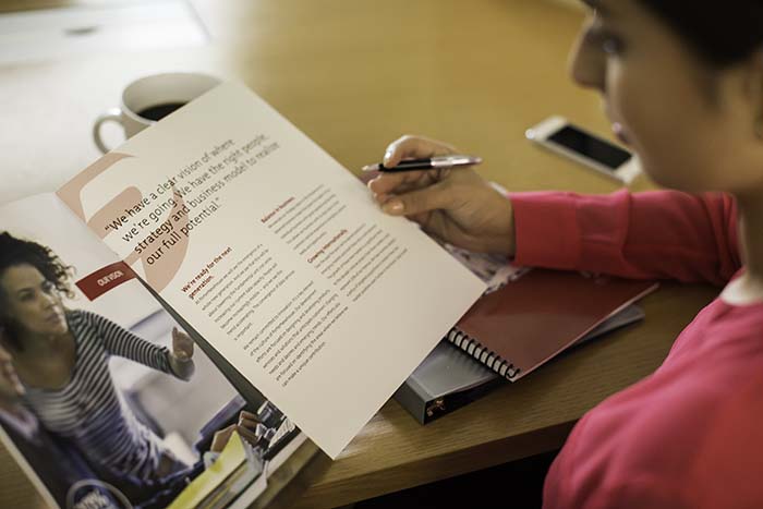Woman reviewing print brochure