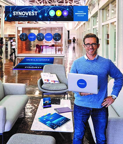 Man holding branded laptop in lobby