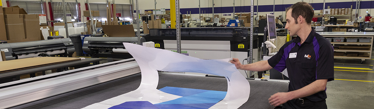 Man unrolling commercial print banner