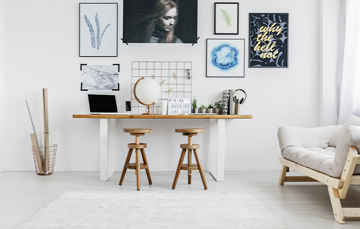 White office space with gallery wall of frames White office space with gallery wall of frames