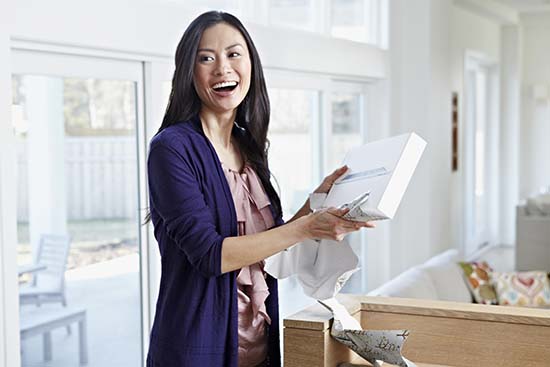 Woman smiling opening box