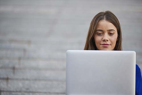 Woman on laptop outside