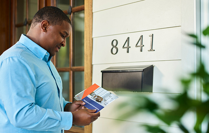 Every Door Direct Mail A person looking at direct mail offers