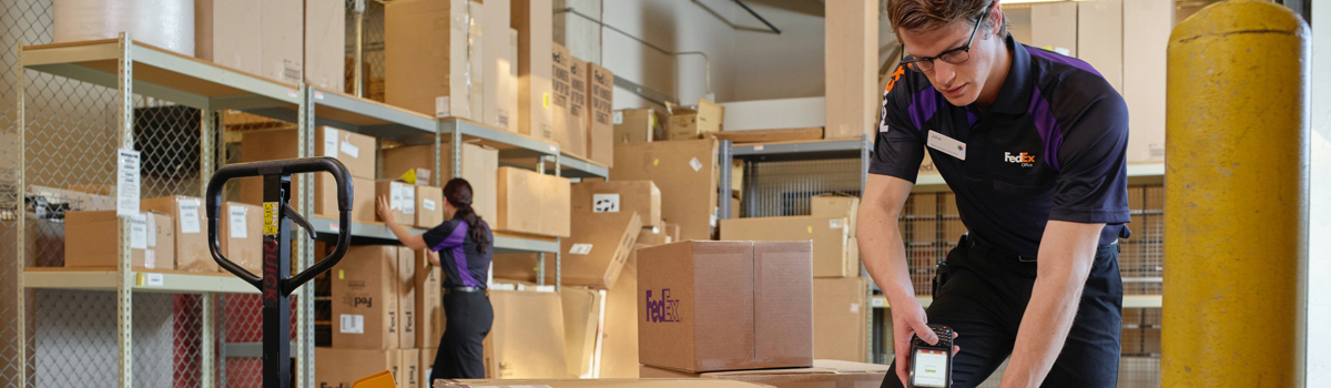 FedEx employee wrapping up a package