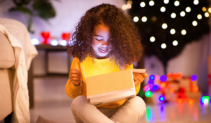 little girl opening a package